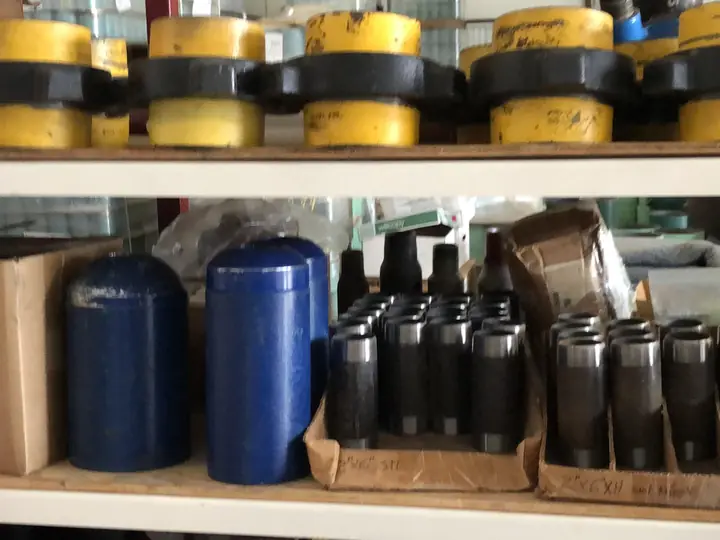 Couplings, thread protectors and fittings on shelves at Reddy Pipe