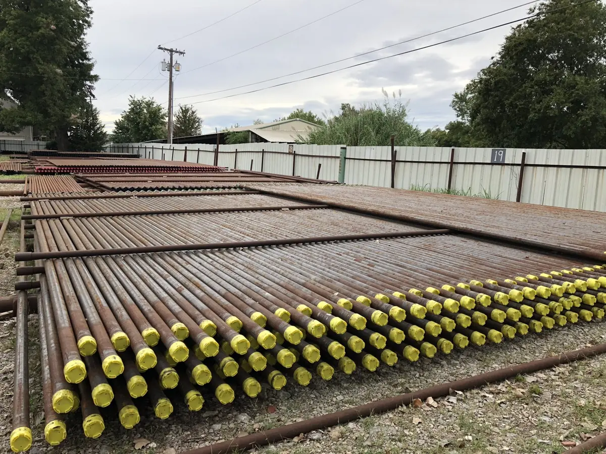 Rows of pipe with yellow thread protectors at the Reddy Pipe yard